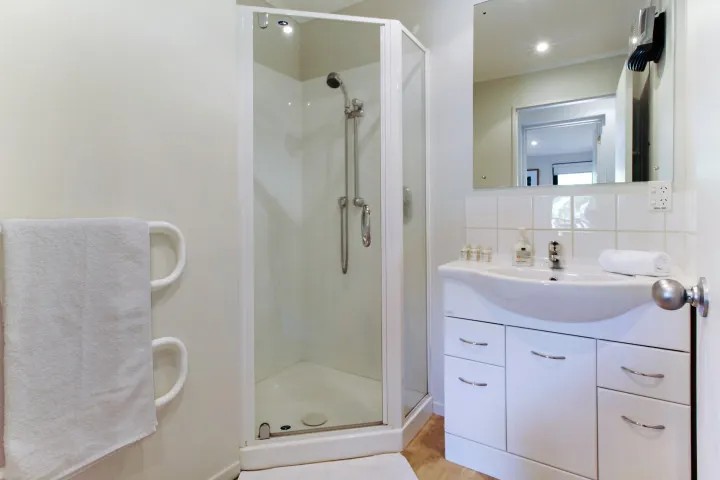 Bathroom in beachfront family home, view of shower and sink