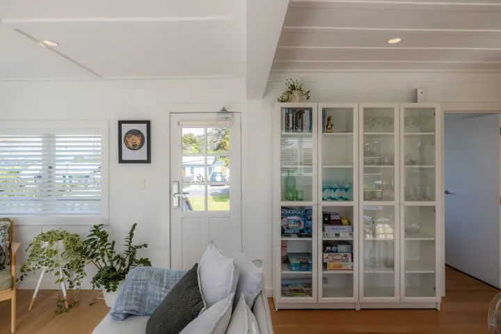 Dining room storage at Tahatai Cottage