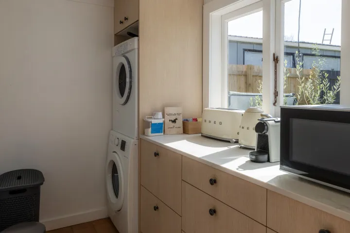 Full laundry area and additional ktichen space at Tahatai Cottage