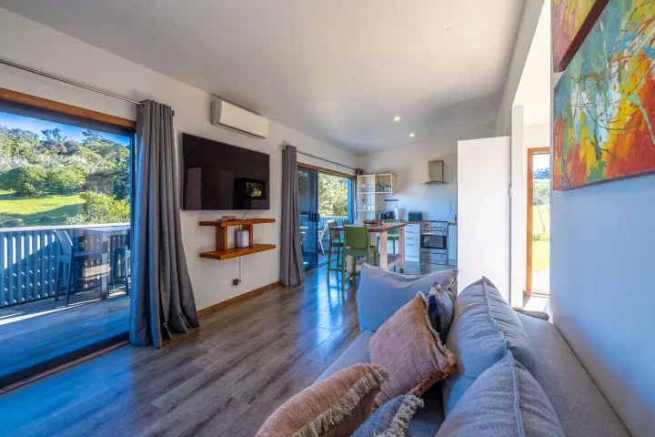 Harvest Cottage Waiheke Island Lounge with vineyard views comfy sofa and large TV