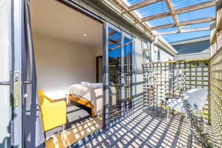 Harvest Cottage Waiheke Island Master bedroom private deck and sitting area
