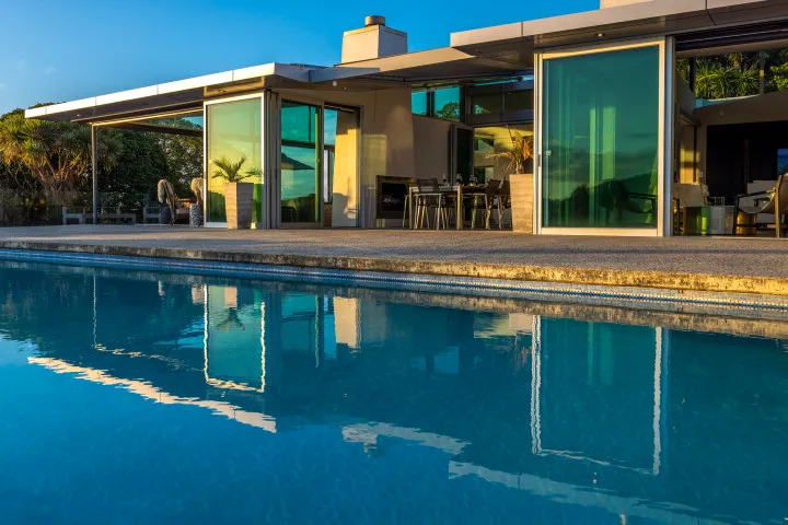 Korora Estate House from inside the pool at dusk