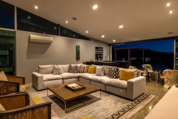 Korora Estate TV room and bar area at dusk