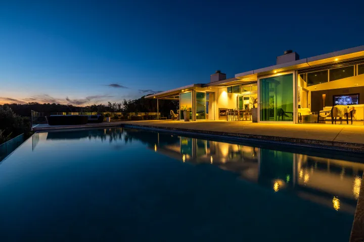Korora Estate View of pool and house at dusk 2
