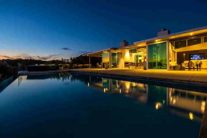 Korora Estate View of pool and house at dusk 2