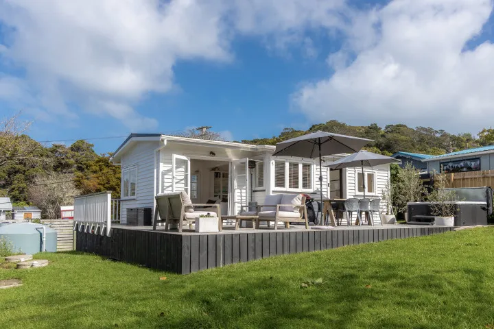 Large deck and lawn area at Tahatai Cottage