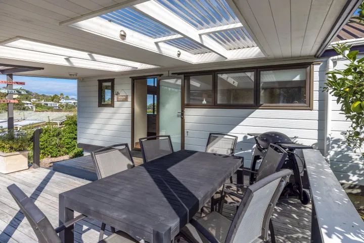 Matai Cottage Waiheke Accommodation Deck dining area with BBQ