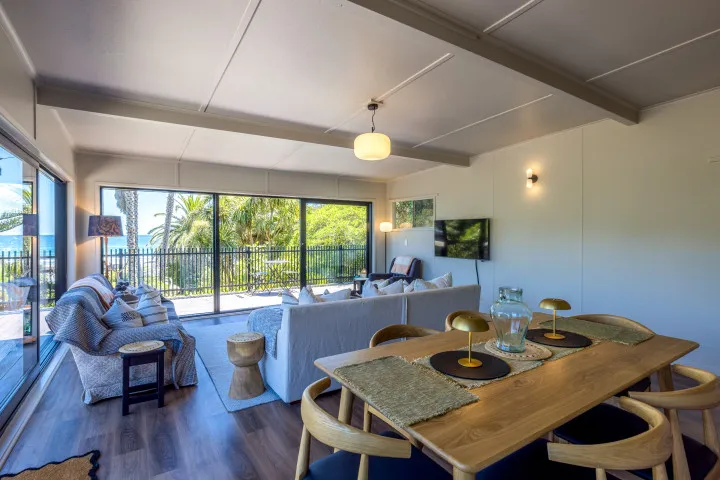 Moana Beach House Open plan living and dining area with TV