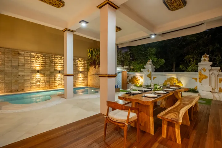 Swarna Mandapa Outdoor dinin and pool area at night