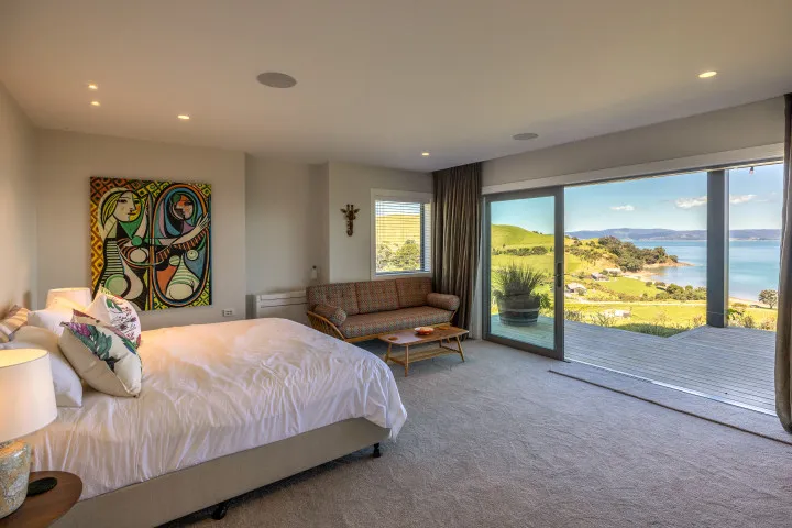 The Keep at Woodside Bay king bedroom with sofa and TV