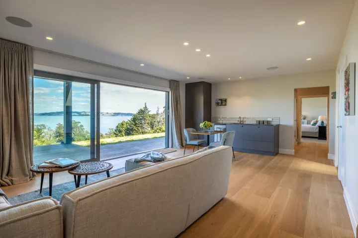 The Keep at Woodside Bay open plan living with large sofa dining area and kitchenette