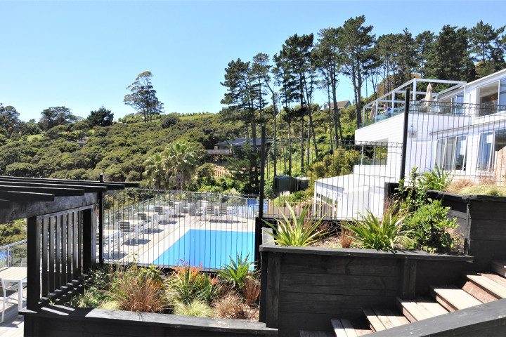 Large outdoor swimming pool with loungers and sea view at The Resort