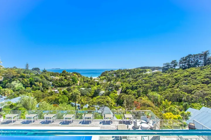 Sunny outdoor infinity pool with loungers at The Resort, Palm Beach