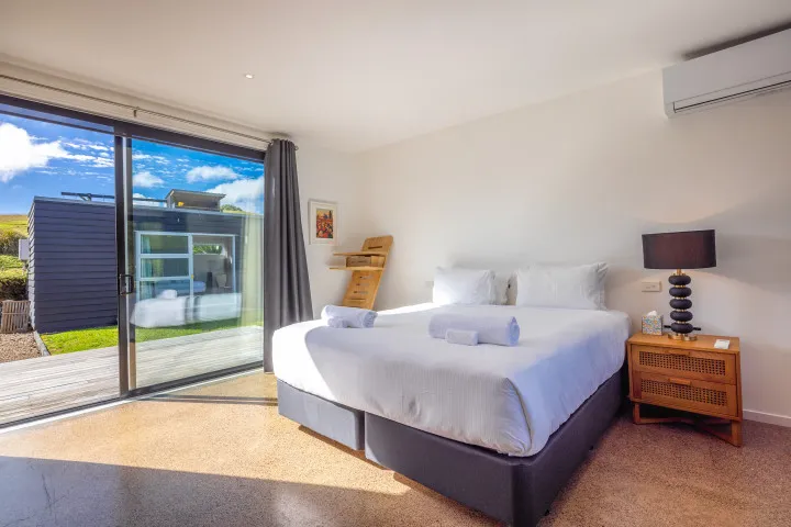 Wharetana Bay Villa Master bedroom with king bed and heatpump